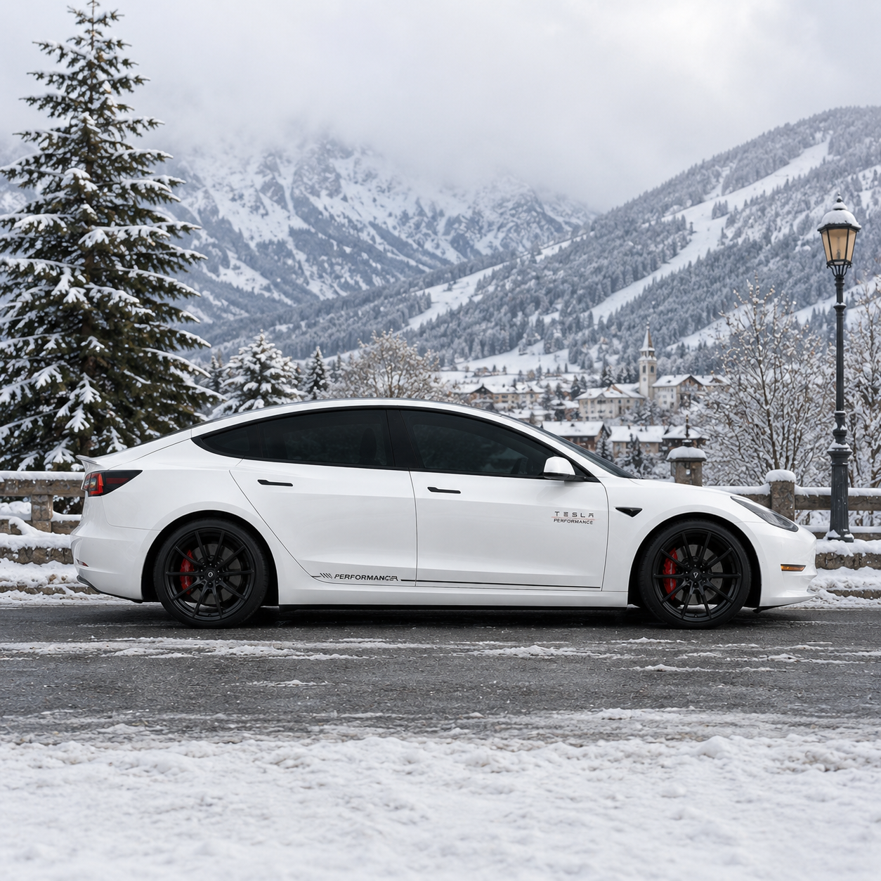 Tesla Model 3 Performance side skirt decal rear three-quarter view in snowy mountain village with church backdrop