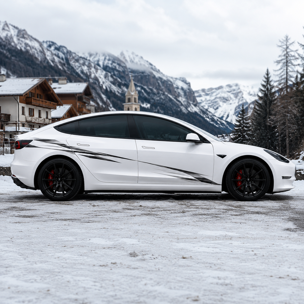 Tesla Model 3 with black slash strike claw side decal parked in snowy alpine village with mountain backdrop