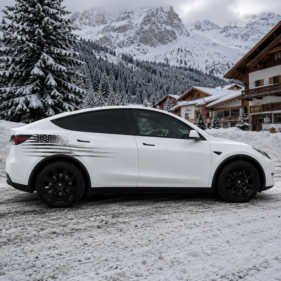 Tesla Model Y distressed American flag wrap decal full side view snowy alpine chalet mountain pine forest background