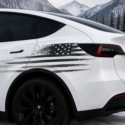 Tesla Model Y distressed American flag decal close-up rear quarter panel black gray brushstroke Stars and Stripes patriotic sticker snowy mountain background