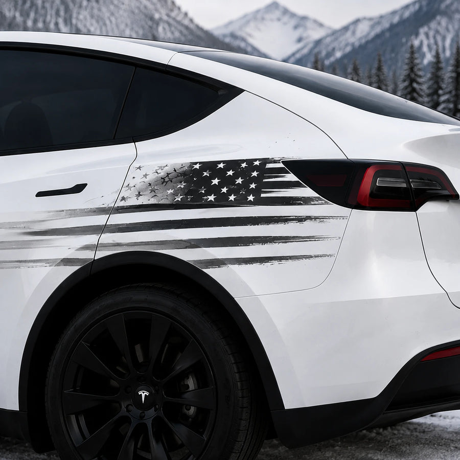 Tesla Model Y distressed American flag decal close-up rear quarter panel black gray brushstroke Stars and Stripes patriotic sticker snowy mountain background