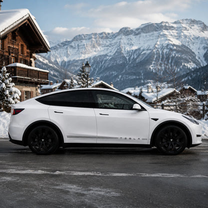 Tesla Model Y minimalist double pinstripe TESLA lettering rocker decal full side view snowy alpine chalet mountain pine tree background