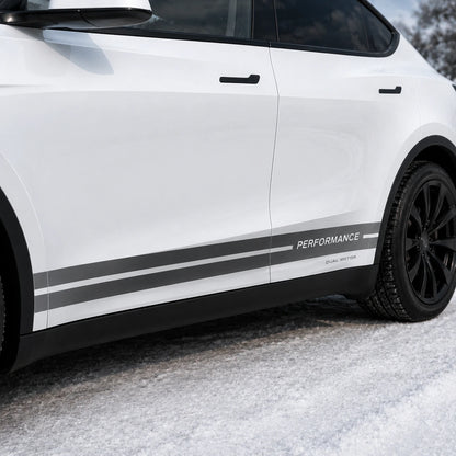 Tesla Model Y Performance Dual Motor rocker panel stripe decal close-up door panel detail gray white PERFORMANCE DUAL MOTOR lettering snowy background