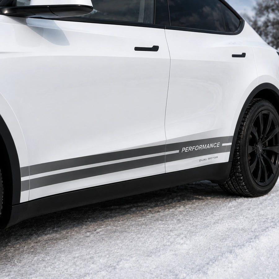 Tesla Model Y Performance Dual Motor rocker panel stripe decal close-up door panel detail gray white PERFORMANCE DUAL MOTOR lettering snowy background