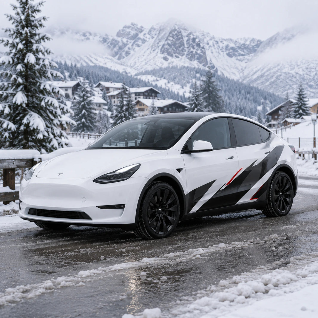Tesla Model Y geometric racing decal wrap front three-quarter view snowy mountain village winter background