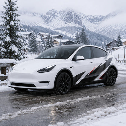 Tesla Model Y geometric racing decal wrap front three-quarter view snowy mountain village winter background
