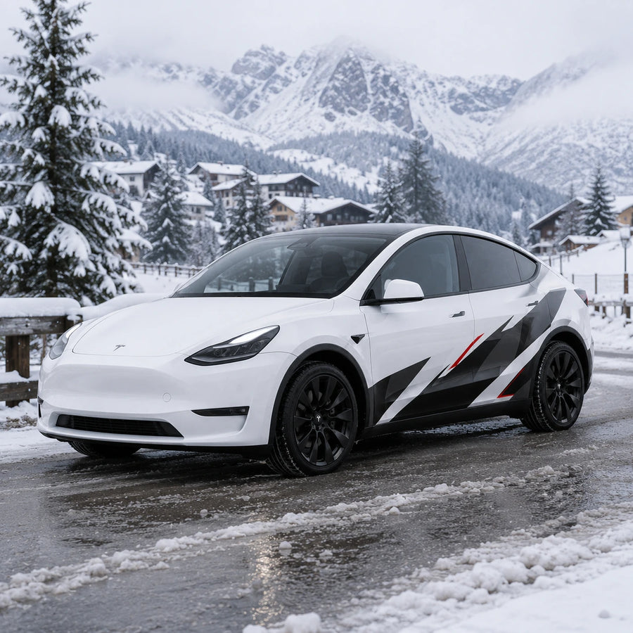 Tesla Model Y geometric racing decal wrap front three-quarter view snowy mountain village winter background