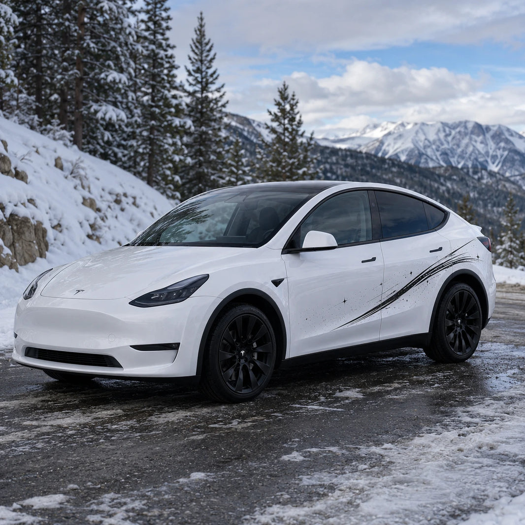 Tesla Model Y shooting star streak side decal front three-quarter view snowy mountain pine forest road winter background black brushstroke sparkle