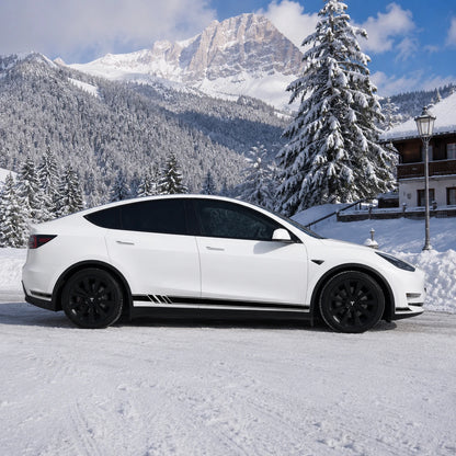 Tesla Model Y black white racing stripe rocker decal full side view snowy alpine chalet mountain pine tree background