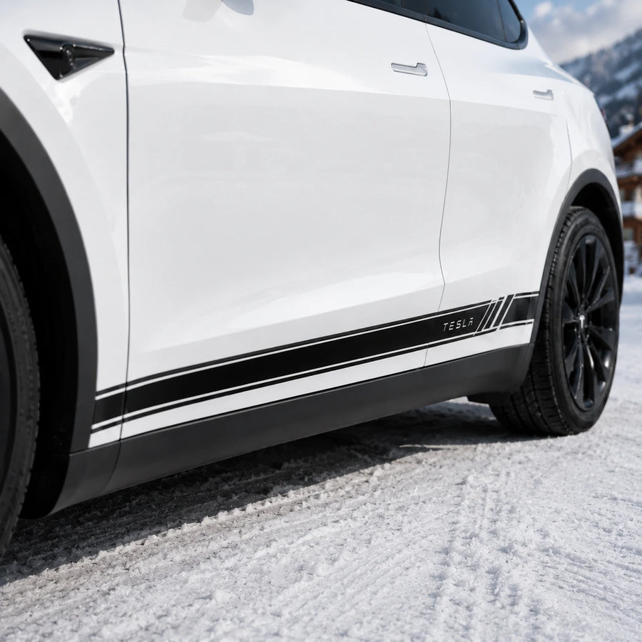 Tesla Model Y side stripe rocker decal close-up door panel TESLA lettering diagonal slash accent detail snowy mountain background
