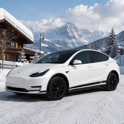 Tesla Model Y TESLA logo side stripe decal front three-quarter view snowy Swiss chalet mountain village winter background