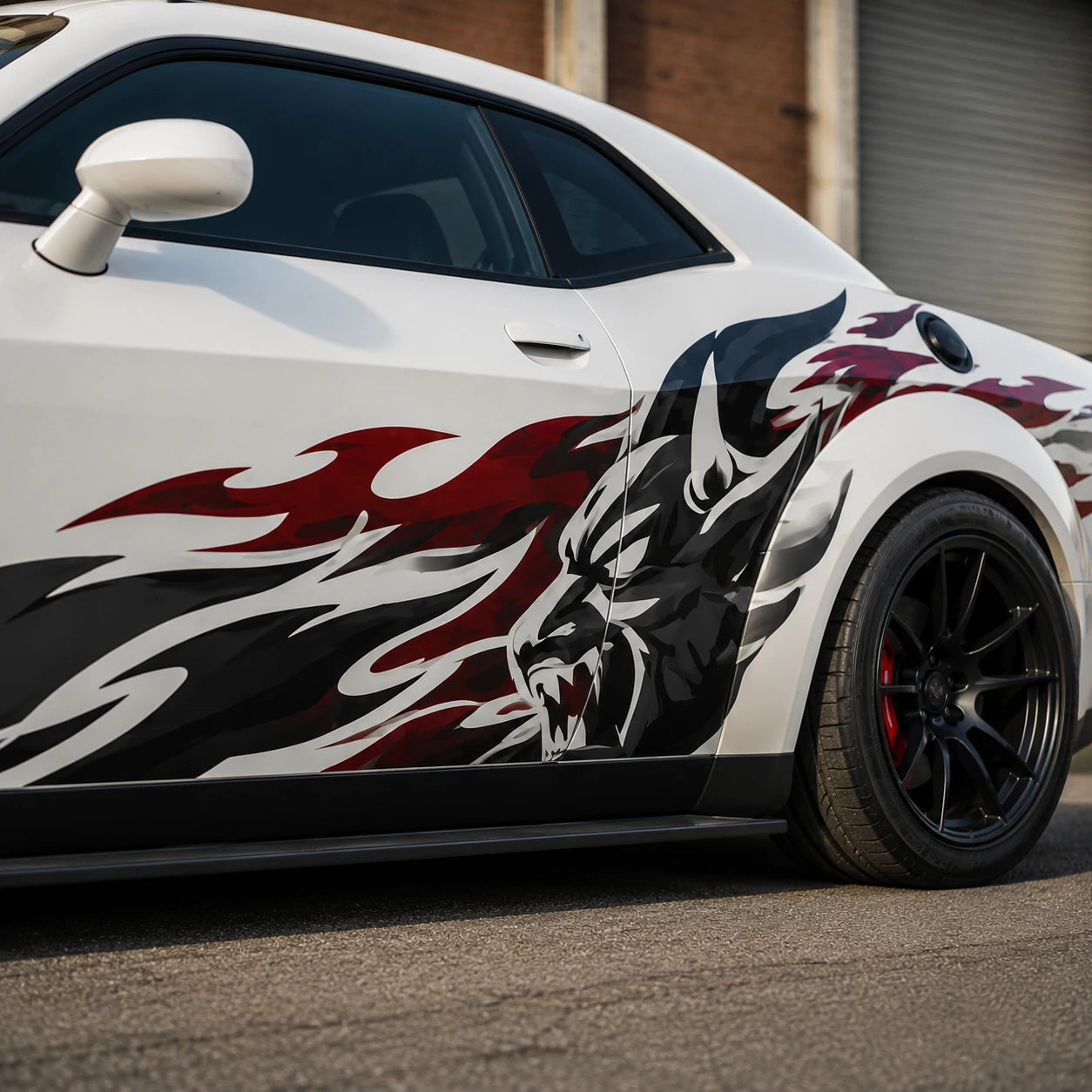 Wolf flame side decal close up on white sports car door and quarter panel industrial background