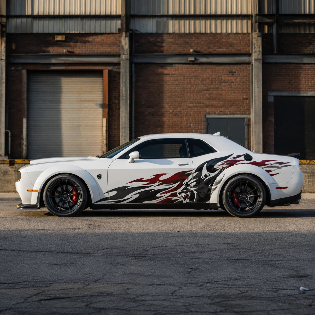 Wolf flame side decal on white Dodge Challenger SRT parked outside industrial warehouse